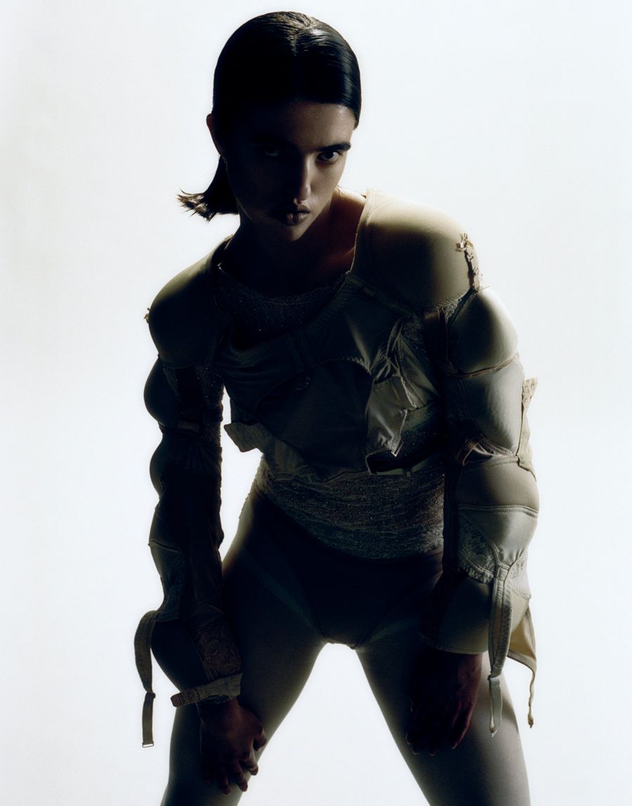 Backlit fashion portrait with a sleek low ponytail